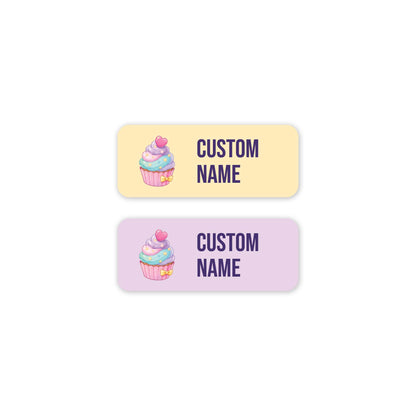Two rectangular custom labels with rounded corners on a white background. The top label is pale yellow and the bottom is pale lavender, both featuring a small cupcake illustration on the left and the text 'CUSTOM NAME' on the right.