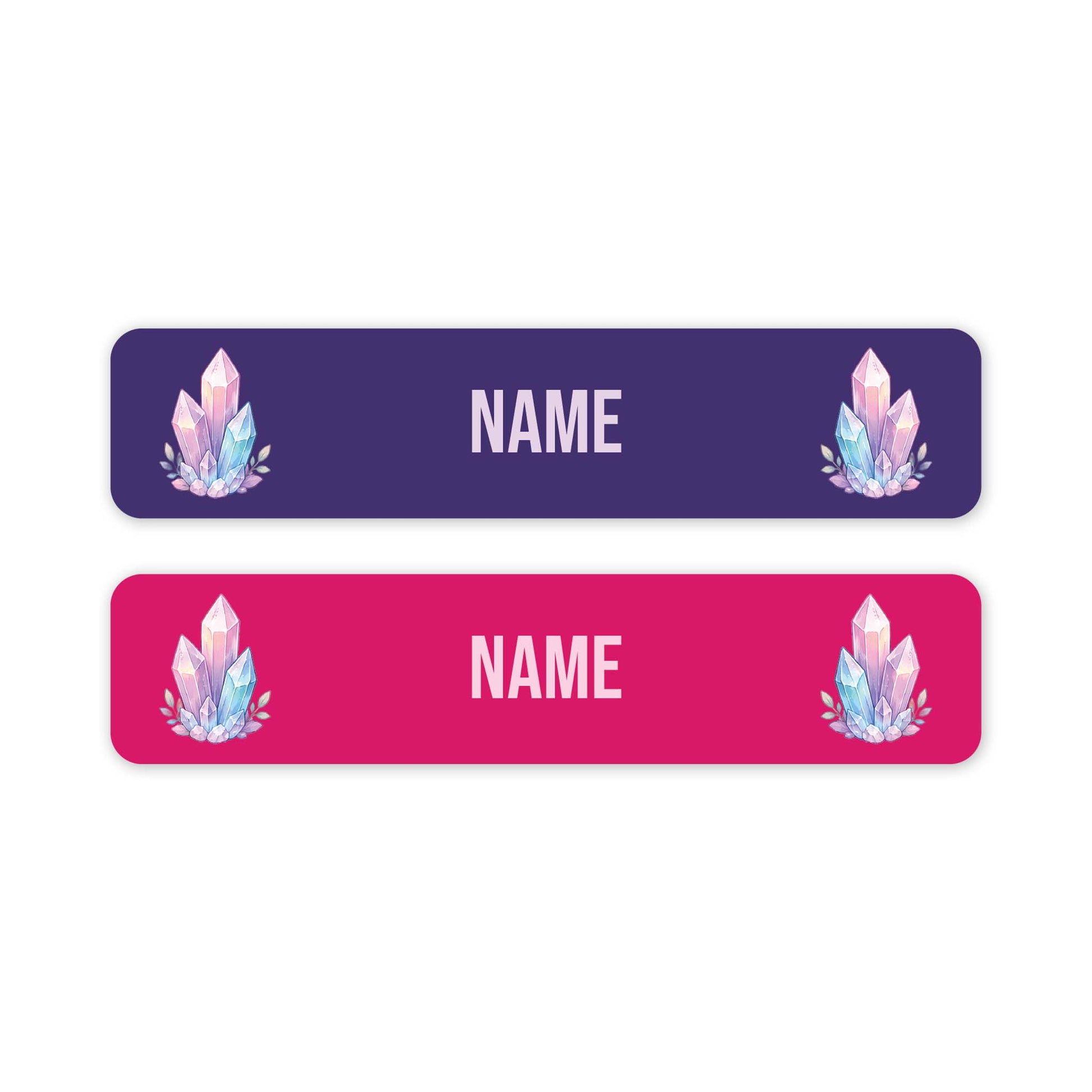 Two horizontal rectangular name tags on a white background, one dark purple and one bright pink, each with rounded corners, customisable 'NAME' text in the centre, and a pastel crystal illustration near the left and right edges.