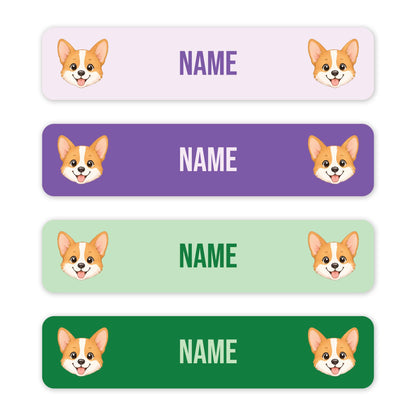 Four rectangular name labels with rounded corners, each showing a corgi face on the left and right and the word NAME in the center. The labels come in four color options: light lavender, purple, light green, and dark green, on a white background.