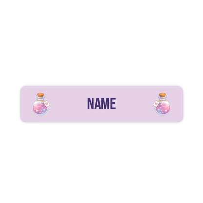 A personalised rectangular label with rounded corners, featuring a light lavender background, the word 'NAME' in dark purple text in the centre, and two cartoon potion bottles on the left and right sides.