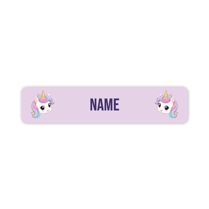 A horizontal lavender name tag or label with rounded corners, featuring two cartoon unicorn illustrations and the word 'NAME' in the center for personalization.